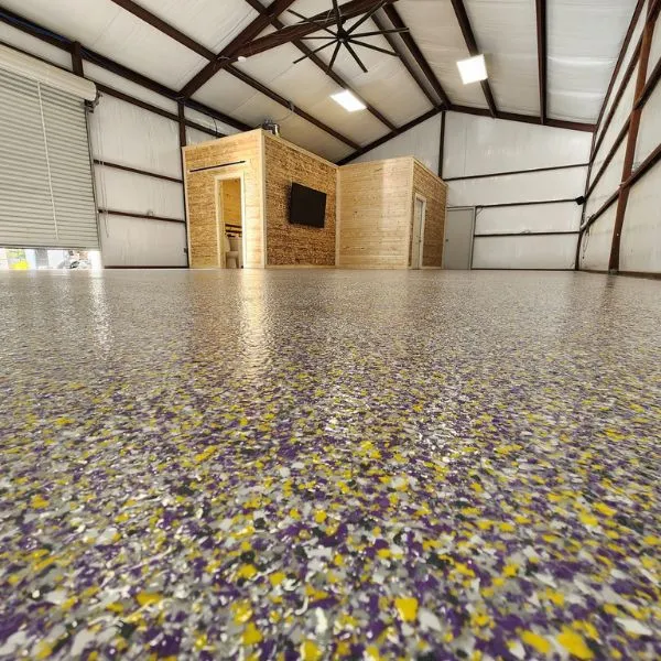 Steel shop building flake epoxy floor by the Ascent Epoxy team